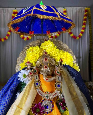 Sacred idol of Lord Ganapathi at Limerick Ganapathi Temple, Ireland, adorned with divine decorations, flowers, and traditional offerings during a pooja ceremony.